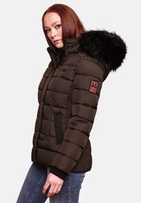 Brown puffer jacket with fur-lined hood, ribbed texture, side pockets, and a logo patch on left sleeve. Casual fit and zip-up design.