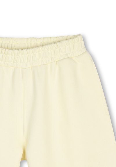 Gele joggingbroek van katoen met een elastische tailleband, een gladde textuur en een ontspannen pasvorm, met zichtbare naden langs de zijkanten.