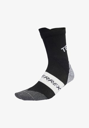Zwarte en grijze sportsocken met een verstevigde teen en hiel. Voorzien van een witte band met het "TERREX" logo en een geribbelde enkelontwerp.