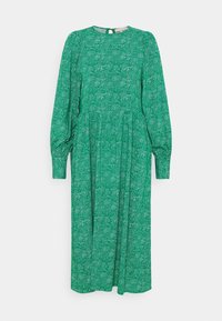 Abito lungo verde con maniche lunghe e scollo rotondo, vita arricciata e un sottile motivo punteggiato bianco. Tessuto morbido con una silhouette fluente.