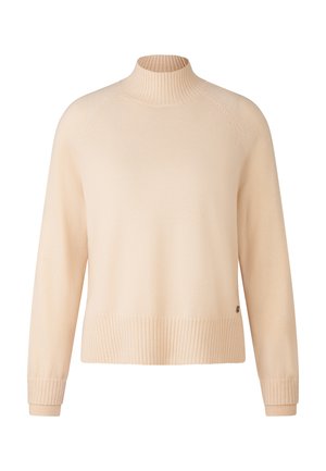 Pull en beige à manches longues avec col montant côtelé, poignets et ourlet, comportant une petite étiquette logo près du bord inférieur sur fond blanc.