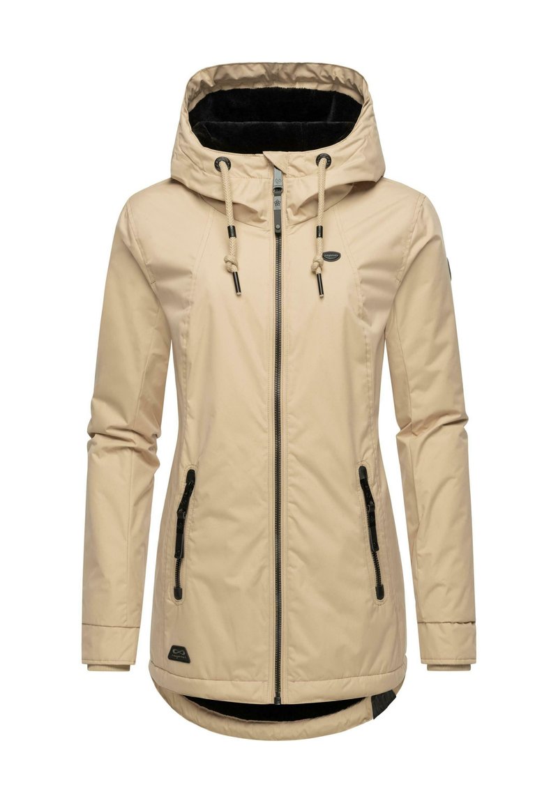 Beige waterproof jacket with a hood, featuring black zippers and a soft black inner lining. Includes drawstrings and a longer back.