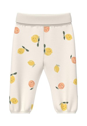 Crèmekleurige peuterbroek met glimlachende gele citroenen en oranje vruchten bedrukt, elastische tailleband en omgeslagen enkels.