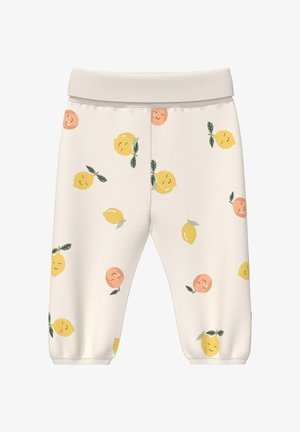 Pantalon pour tout-petit couleur crème avec citrons jaunes souriants et fruits orange imprimés, taille élastique et chevilles avec revers.