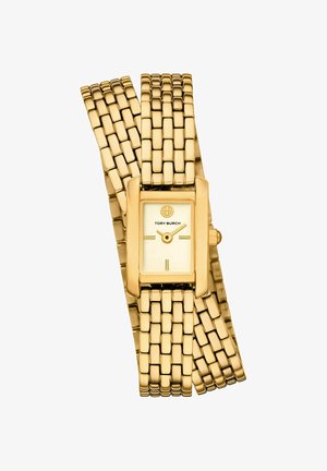 Guldtonet Tory Burch ur med rektangulært urværk og omviklet kædearmbånd, der viser klokken 3:10.