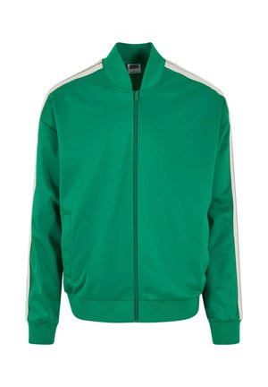 Veste de piste verte avec fermeture éclair à l'avant, col montant, poches latérales et bandes blanches sur les épaules. Fabriquée en tissu lisse et léger.
