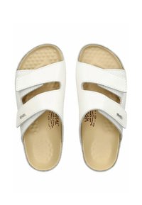 White slide sandals with two adjustable straps. Soft textured footbed, rubber sole. Slightly rounded toe. Minimalist design with subtle branding.