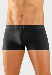 Črne bokserice iz gladkega materiala, s soft elastičnim pasom z logotipom "H.I.S.". Prilegajoča zasnova s konturirano žepe.