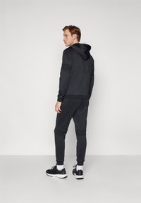 Sergio Tacchini MORET PANTS - Treniņtērpa apakšdaļas - black