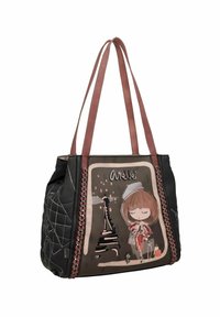 Sac fourre-tout noir et beige avec des anses en cuir marron, présentant un motif d'une fille et de la Tour Eiffel. Accentué par des coutures décoratives.