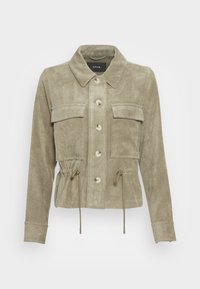 Light green corduroy jacket with a collared neckline, front pockets, and drawstring waist. Features button closures and textured fabric.