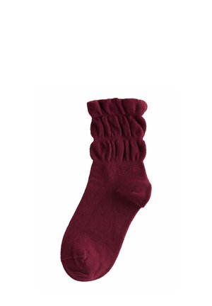 Calzino in maglia bordeaux con texture arricciata al polsino, materiale morbido, lunghezza a metà polpaccio e finitura liscia.