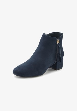 Dark navy suede ankle boot with a pointed toe, side zipper featuring a tassel accent, and a low block heel. Smooth texture.