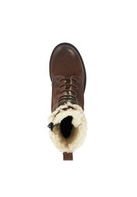 Bruin leren veterschoen met een donzige crèmekleurige kraag, ronde neus en zwarte zool. Voorzien van een lus aan de achterkant voor gemakkelijk aan- en uitrekken.