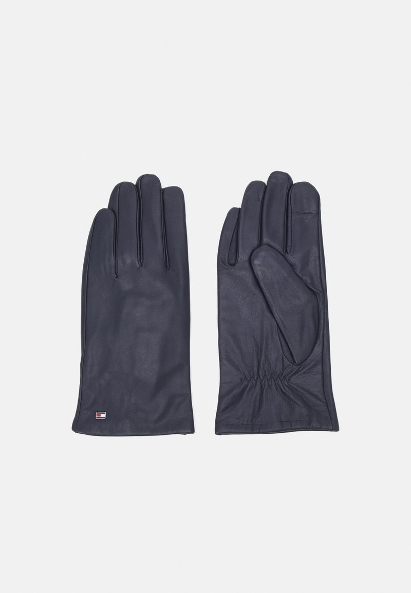 Dark navy leather gloves with a smooth texture and elasticated wrist. Feature five fingers, with a tonal logo on the cuff.