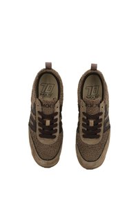 Brown fleece-textured sneakers with dark brown laces, suede accents, and "Back 70" logo inside the shoe.