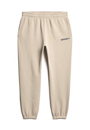 Beige katoenen joggingbroek met elastische tailleband en boorden, uitgerust met zijzakken en het "SUPERDRY"-logo in het blauw op het bovenste deel van het rechterbeen.