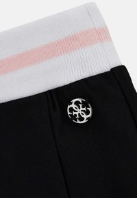 Black athletic shorts with a white and pink striped waistband, featuring a silver logo accent on the side. Smooth fabric texture.