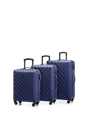 Three hard-shell suitcases in navy blue, featuring a diamond pattern, black handles, and four wheels for easy mobility.