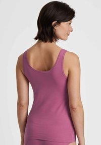 Pink, sleeveless tank top with a fitted design, soft texture, and a rounded neckline, showcasing a smooth back seam and minimal stitching details.