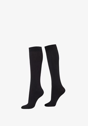 Paire de chaussettes noires unies montant jusqu'aux genoux, présentées sur un fond blanc.