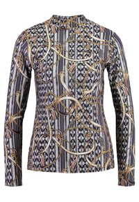 Långärmad topp med ett mönster av kedjor, fransar och geometriska former i marinblått, guld och kräm på ett texturerat tyg.