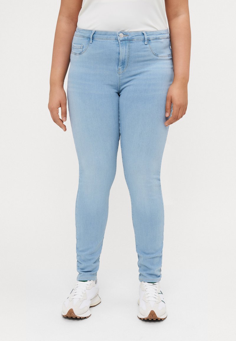 Light blue, slim-fit jeans with a mid-rise waist, a single button closure, and front pockets, made from denim fabric.