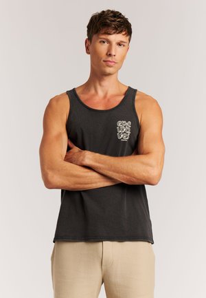 Schwarzes Tanktop mit rundem Ausschnitt und einem grauen Logodetail auf der linken Brust. Das Material wirkt weich und bietet eine legere Passform.