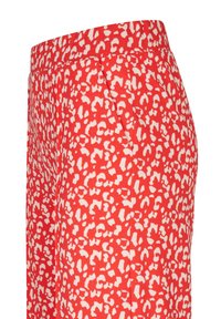 Rode broek met een abstract wit patroon, voorzien van een gladde textuur en een elastische tailleband voor comfort.