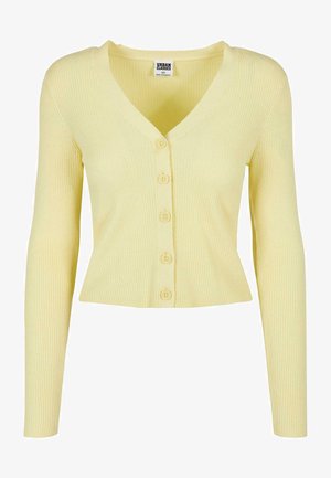 Kollane ribaga kardigan sügava V-kaeluse, pikkade varrukate ja kuue esivajutusega nupuga. Kujundusel on istuv, lühike siluett.