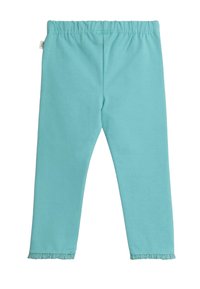 Tirkizs krāsas leggins ar mīkstu, elastīgu audumu. Iespējas ietver elastīgu jostu un drapētas apakšmalas ap potītēm.