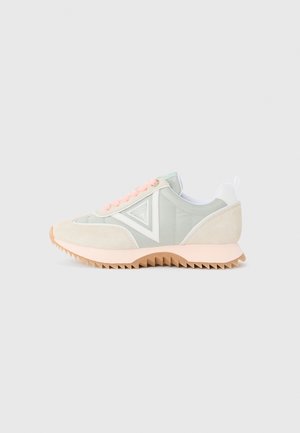 Light green sneakers with suede and nylon materials, pink laces, white accents, and a textured, zigzag rubber sole.