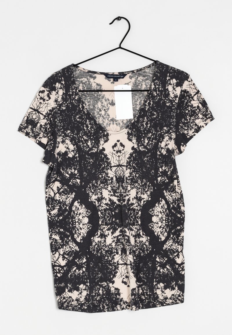 Zwart en crèmekleurig top met korte mouwen en een bloemenpatroon, met een V-hals en zachte, gestructureerde stof. Label bevestigd aan de halslijn.