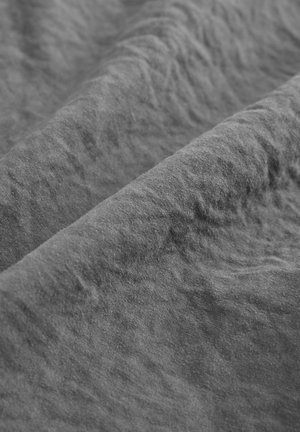 Gray, textured fabric with a matte finish, featuring soft, wrinkled folds that create depth and dimension. No visible patterns or accents.