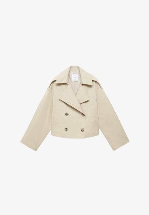 Jachetă bej, scurtă, cu dublă pieptărie, realizată din bumbac. Are nasturi mari, două buzunare frontale și un rever lat cu guler deschis.