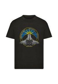 Black cotton t-shirt featuring a graphic of the Space Shuttle Atlantis, with yellow and blue accents, and text detailing mission STS-132.