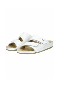 White slide sandals with open toe, made of glossy synthetic material. Features two Velcro straps and a textured insole for grip.