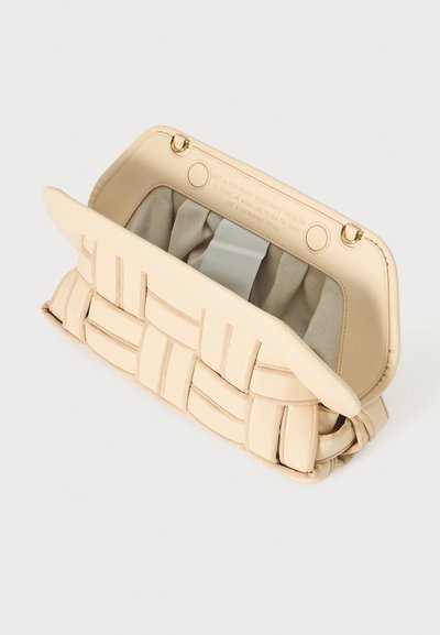 Beige geflochtener Handtasche mit strukturiertem Design, ausgestattet mit glattem Äußeren, gefüttertem Innenraum und goldenen Hardware-Akzenten. Schließt mit einem Verschluss.