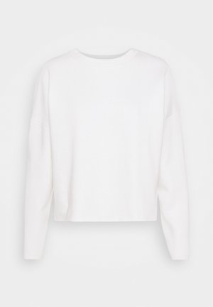 Felpa bianca a taglio corto con maniche lunghe, scollo ampio e tessuto morbido e strutturato. Nessun motivo o decorazione.