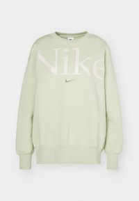 Light green Nike sweatshirt featuring large white lettering and multicolored logo. Ribbed cuffs and hem with a classic crew neck design.