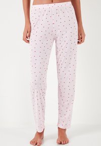 Light pink pajama bottoms feature small red heart patterns, an elastic waistband, and a straight-leg design made of soft fabric.
