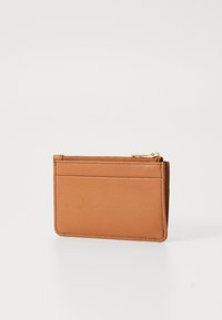 Tan leather cardholder with a zip compartment, featuring three card slots on one side and a smooth texture, minimalist design.