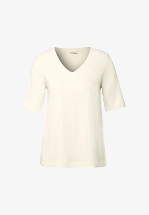 Biała bluzka z krótkim rękawem z dekoltem w serek i teksturowaną powierzchnią. Prosty krój z luźnym fasonem i prostym dołem.