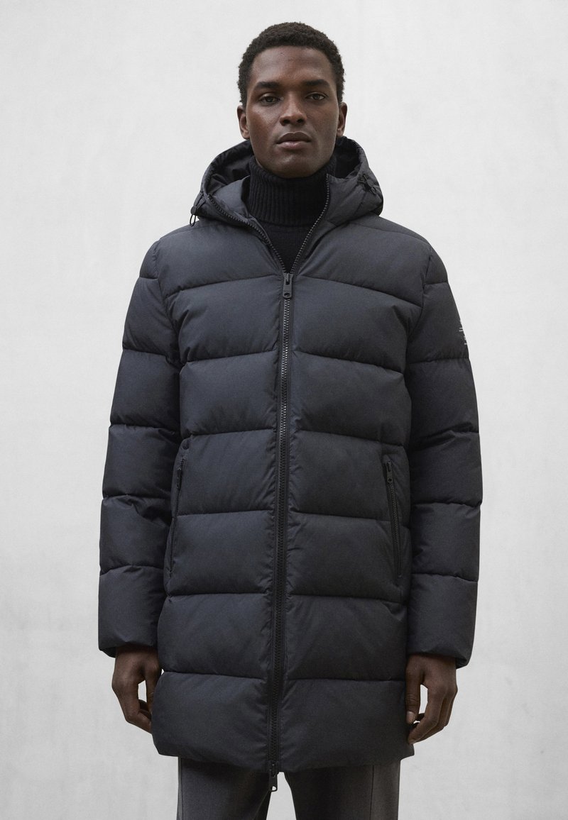 Kurtka puchowa w jednolitym czarnym kolorze, z zamkiem błyskawicznym z przodu, kapturem i pikowaną konstrukcją. Gładka tekstura z poziomymi przeszyciami i kieszeniami po bokach.