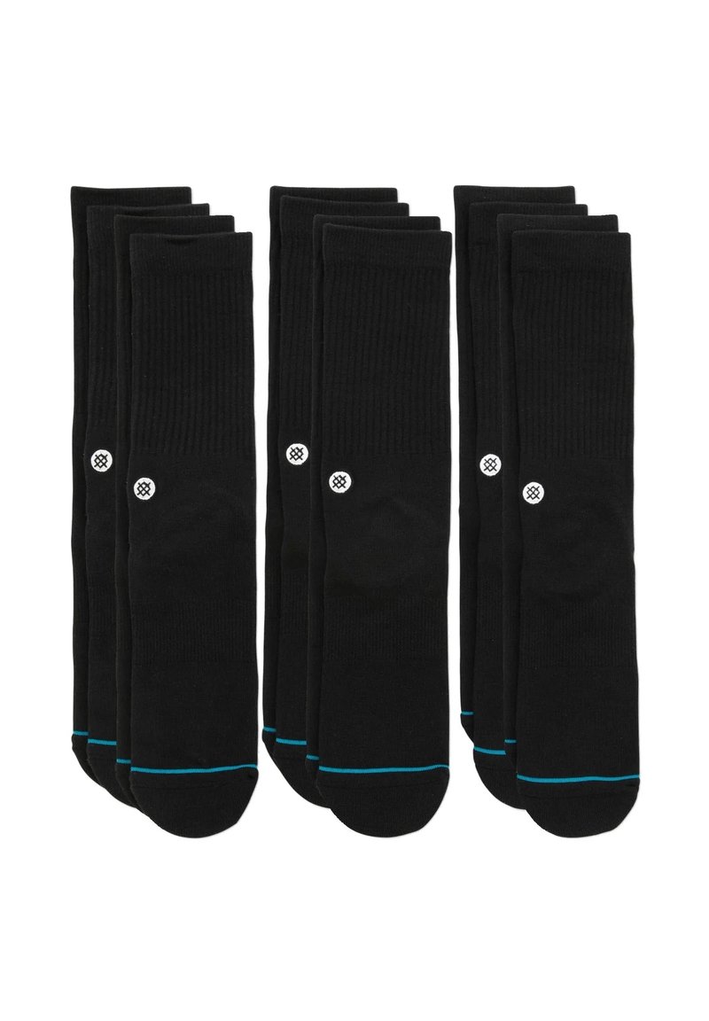 Calcetines de algodón negros, con textura acanalada, que presentan un logo blanco y un ribete azul en la parte superior. Conjunto de múltiples pares dispuestos en filas.