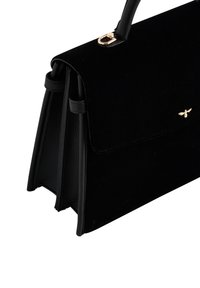 Black handbag made of velvet and leather, featuring a structured design, gold hardware accent, and a flap closure at the top.