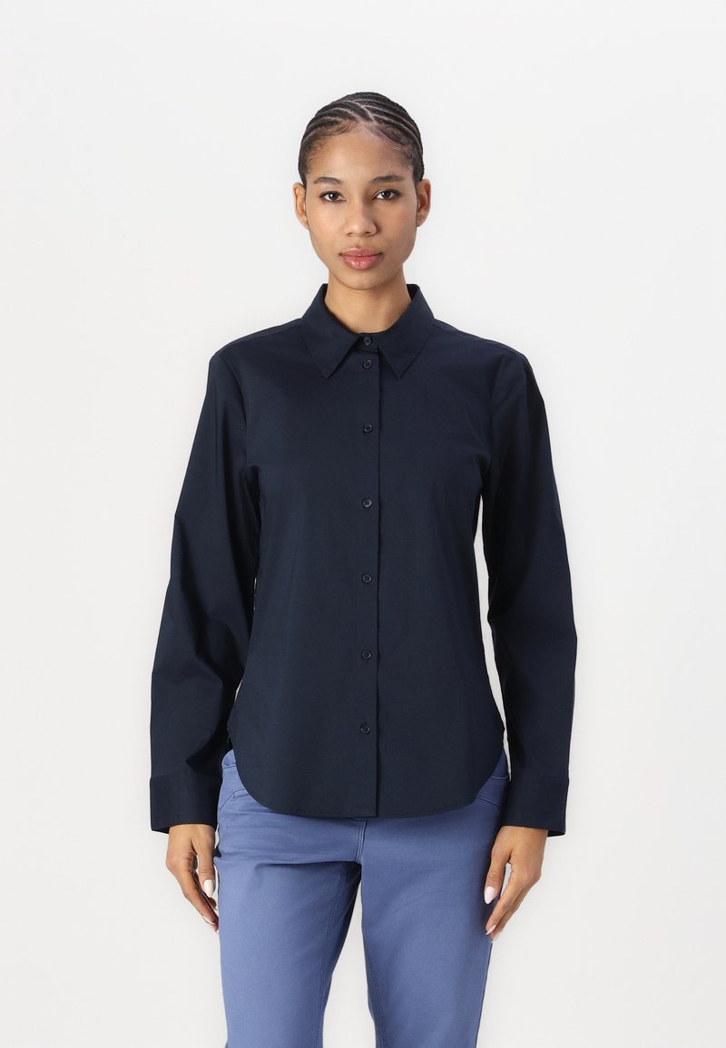 Navy blue long-sleeve shirt with a button-down collar, featuring a smooth texture and a slim fit design. Pin-tucked hair shown.