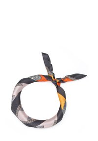 Silk scarf featuring a mix of orange, gray, and beige colors with geometric and floral patterns, tied in a knot at the center.