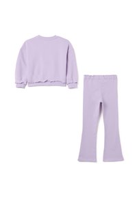 Lilac jogger set featuring a crew neck sweatshirt with ribbed cuffs and a pair of matching flared pants with an elastic waistband.