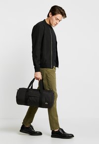 Lacoste ROLL BAG - Sports bag - black